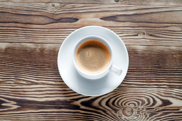 Coffee cup and cookie on wood