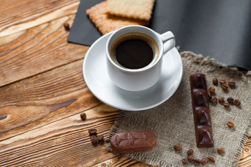Coffee cup and cookie on wood