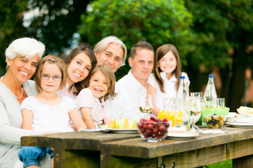 Big Family Having A Picnic In The Garden