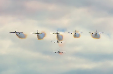 Aircraft fighter jets smoke the background of sky c ouds