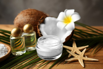 Fototapeta na wymiar Spa composition with body care products and coconut on wooden background
