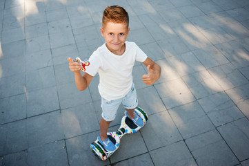 A little boy plays with spinners. She holds the spinners in her hands.