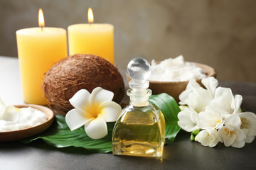 Obraz na płótnie Canvas Beautiful spa composition with coconut body care products and candles on table
