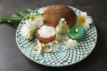 Beautiful spa composition with oil in bottle and coconut on platter