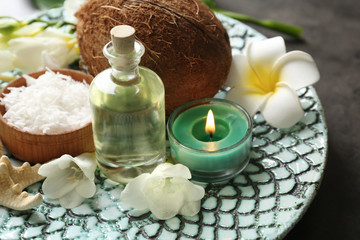 Beautiful spa composition with oil in bottle and coconut on platter