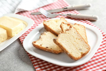 Plate with delicious sliced butter cake on table