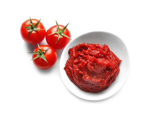 Bowl with sauce and tomatoes on white background