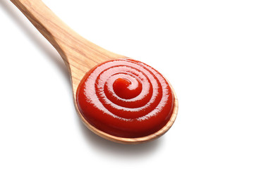 Wooden spoon with tomato sauce on white background