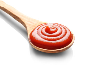 Wooden spoon with tomato sauce on white background
