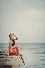 A girl in a swimsuit on a pier