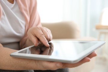Old woman with tablet, closeup
