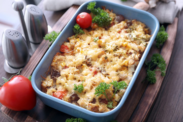 Baking tray with delicious turkey casserole on table, closeup