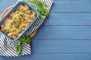 Composition with delicious turkey casserole on wooden table