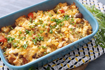 Baking tray with delicious turkey casserole on table, closeup