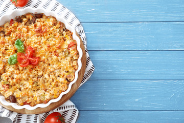 Composition with delicious turkey casserole on wooden table