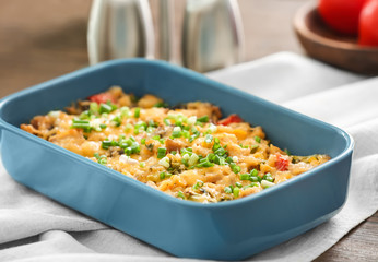 Baking tray with delicious turkey casserole on table