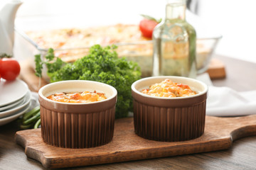 Ramekins with delicious turkey casserole on table