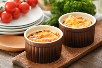 Ramekins with delicious turkey casserole on table