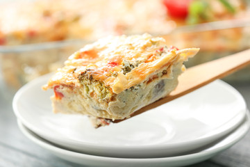 Spatula with piece of delicious turkey casserole, closeup