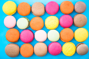 Fototapeta na wymiar Colorful macaroon cookies, flat lay