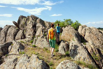 Girls with a backpack walk in picturesque places.