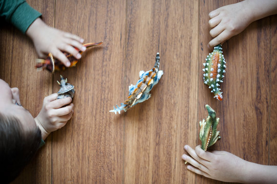 children playing with dinosaur toys