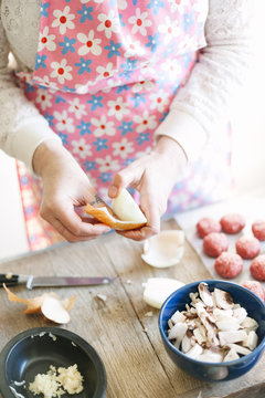 Woman peeling an onion.