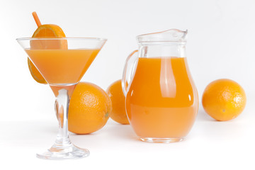 Glass jar and glass with orange juice.