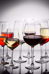 Set of party high wine glasses with red, white and rose wine