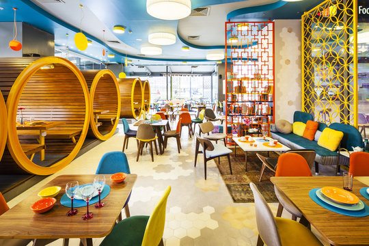 Wide shot of colorful interior of modern cafe