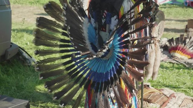 View of part of Peruvian dress made of feathers on true Peruvian playing flute and dancing outdoors