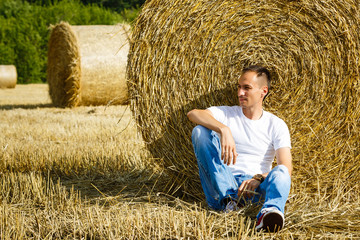 Naklejka na ściany i meble young businessman on yellow wheat field
