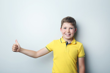 Portrait of young boy on grey background