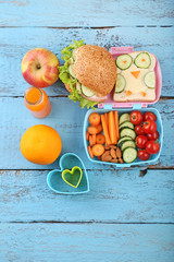 School lunch in boxes with fruits on blue wooden table