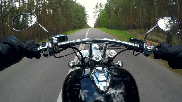 A POV biker shot riding in the country.   