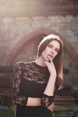 Fototapeta premium Portrait of sensual young woman posing at the city in summer