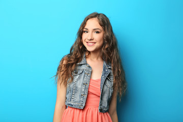 Portrait of young woman on blue background