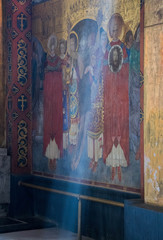 Fototapeta na wymiar Wall color paintings on the wall of the temple depicting the life of the saints