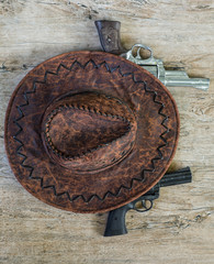 Cowboy hat and revolver on the table