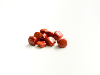 Tumbled Red diaspor stones for crystal therapy treatments and reiki detail isolated