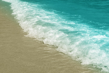 Wave on the shore, blue toning, pastel colors, background.