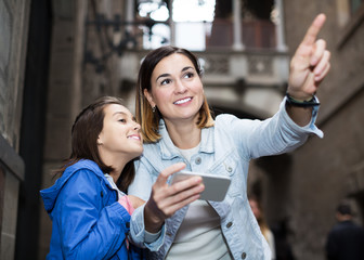 Mother and daughter with phone