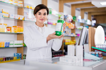 Woman pharmacist showing assortment of care products