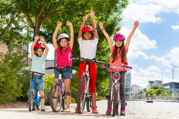 Obraz premium Happy little winners with their bikes at park