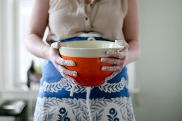 Woman holding orange bowl