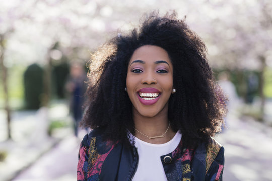 closeup of young stylish black woman laughing looking at the camera
