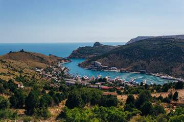 Fototapeta na wymiar Beautiful view of the Black Sea and Balaklava Bay. Panorama view to city, ships and port