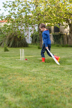 Child playing cricket match