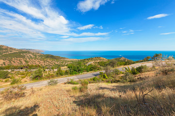 Fototapeta na wymiar The road through the hills near the coast. The Peninsula of the Crimea, the Black sea coast