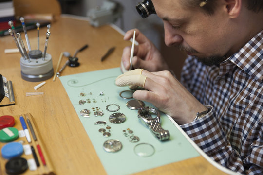 Clockmaker working in workshop